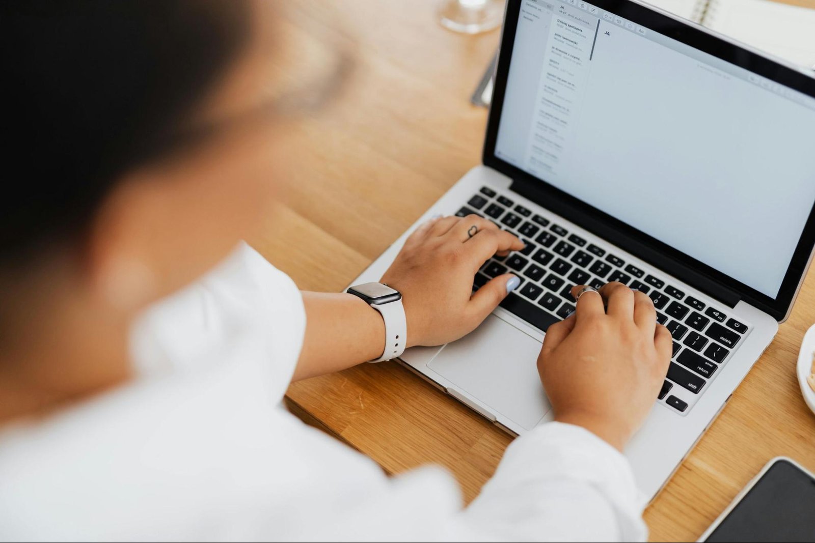 A woman typing on her laptop